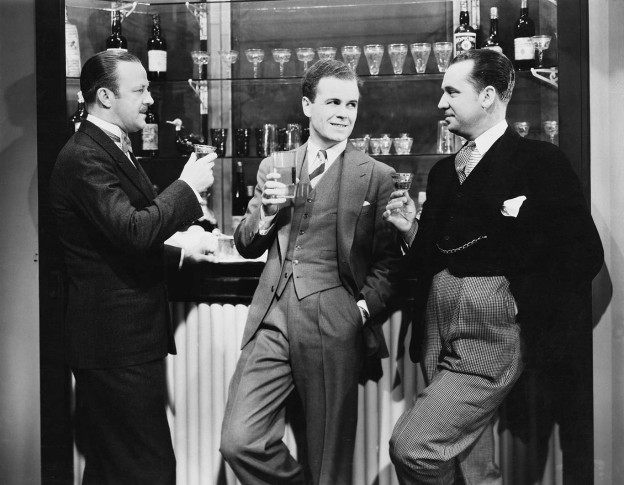 Businessmen drinking together at bar