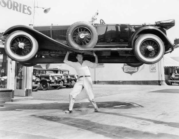 Strong man lifting a car over his head